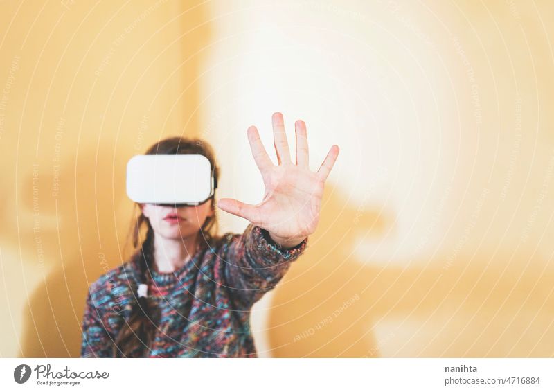 Spontaneous portrait of a young woman using cardboard vr glasses metaverse technology sustainability gamer virtual reality future progress concept surreal