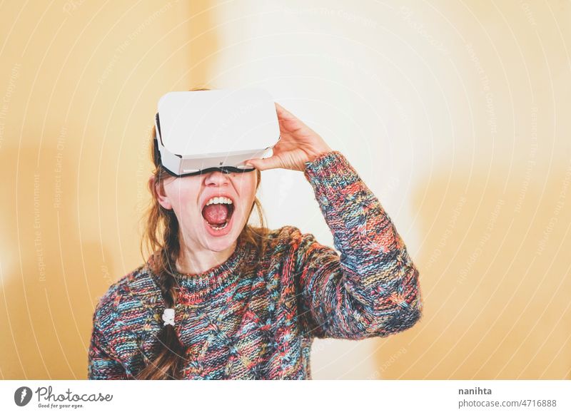 Spontaneous portrait of a young woman using cardboard vr glasses metaverse technology sustainability gamer virtual reality future progress concept surreal