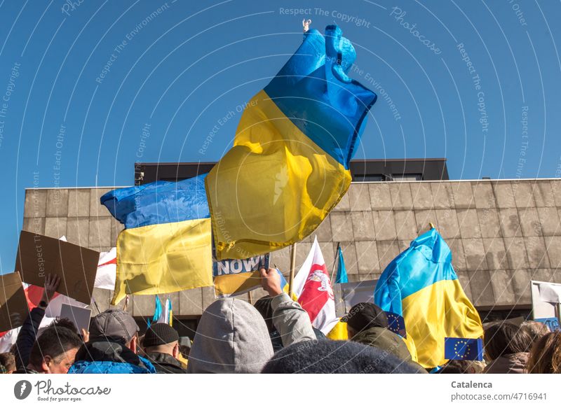 Waving flags of Ukraine Sky Demo Town Architecture Manmade structures European Union slew ehen Flag War soon Yellow Politics and state Sign Demo sign