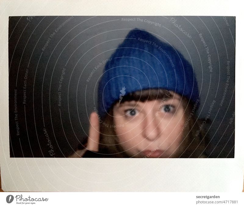 Finger hat Duckface Polaroid Woman Cap Winter frightened esteem Fingers Human being Face portrait Hand Adults Blue Frame Dark Interior shot Head Light Looking