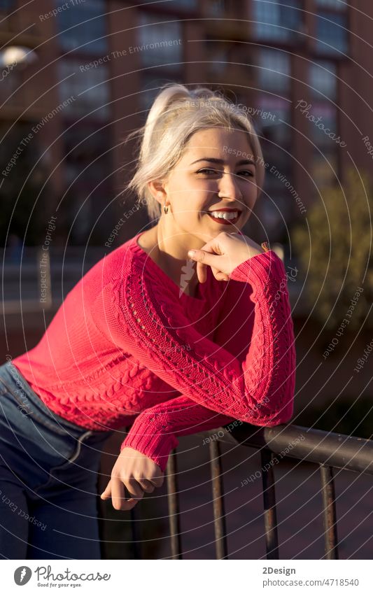 Woman standing against the city holding out a blank mobile phone towards the camera with focus to the cellphone attitude carefree confidence confident