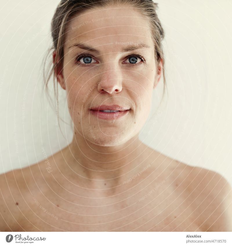 square portrait of young tall north german blonde woman with blue eyes looking directly and straight into camera Woman Large Blonde North German Athletic Slim