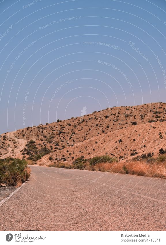 Taberna desert landscape of Almeria, Spain, in which a road can be seen tumbleweed almeria andalusia spain western highway travel asphalt utah usa nature sky