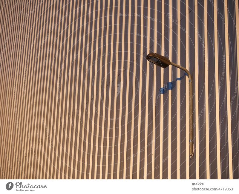 Lonely street lamp on a wall streetlamp Street lighting Lantern Wall (building) Hall Lamp Lighting Lamp post Corrugated sheet iron Shadow obliquely Sun Pattern