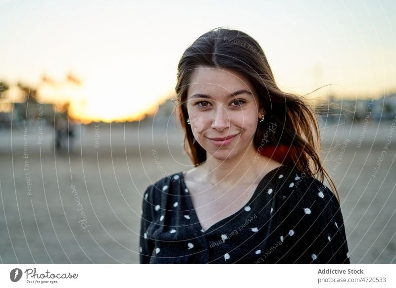 Charming woman standing on beach coast shore seaside pastime leisure seafront feminine recreation smile appearance style city enjoy cheerful summer positive