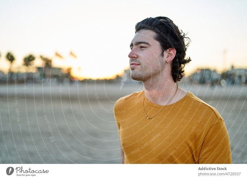 Man standing on beach man coast shore seaside pastime leisure seafront rest appearance style smile city enjoy cheerful summer positive optimist glad delight