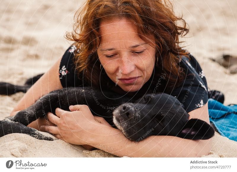 Woman with dog lying on beach woman pet sleep rest shore recreation chill animal tourist resort seashore sand seaside seacoast feminine style nature summer