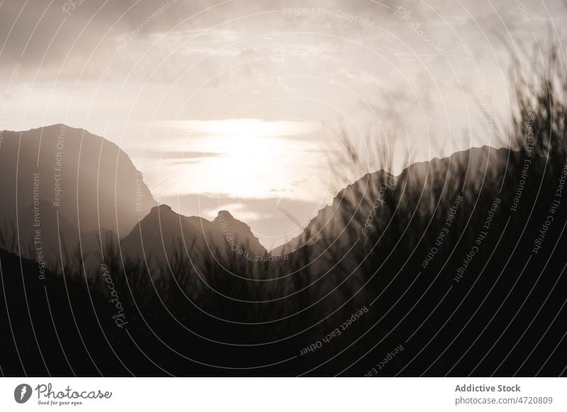 Range of hills on coast of ocean under clouds range silhouette nature environment slope scenery horizon landscape cloudy shore wild high island seascape endless