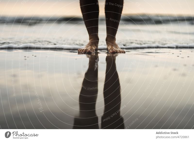 Unrecognizable man on wet beach traveler leg sea island pastime trip splash water adventure waterfront seashore spain canary tenerife nature summer male