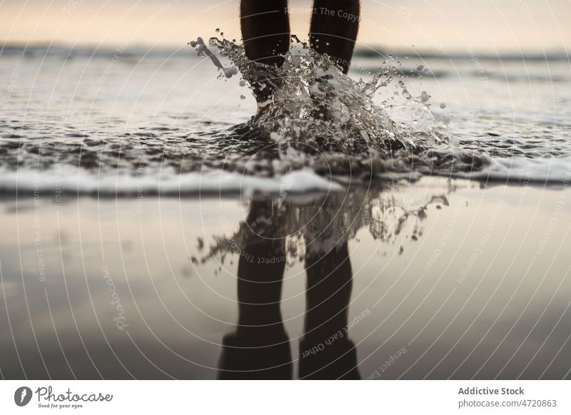 Unrecognizable man on wet beach traveler leg sea island pastime trip splash water adventure waterfront seashore spain canary tenerife nature summer male