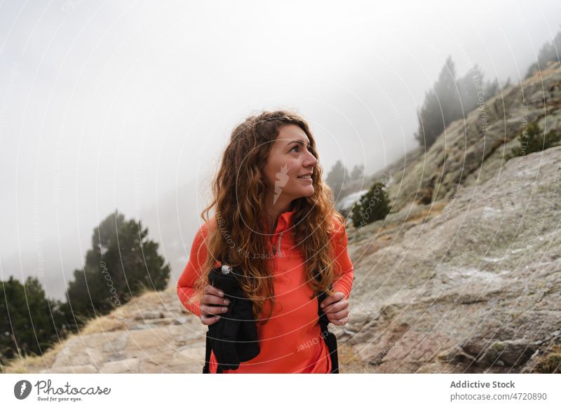 Woman on rocky cliff in nature woman traveler hiker mountain highland trekking adventure journey explore activity trip wanderlust slope explorer tourist active