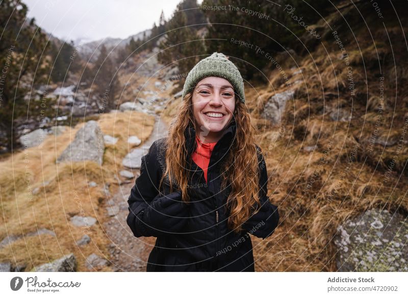 Cheerful woman hiking in nature traveler hiker trekking adventure journey explore pastime leisure trip activity wanderlust explorer tourist active vacation