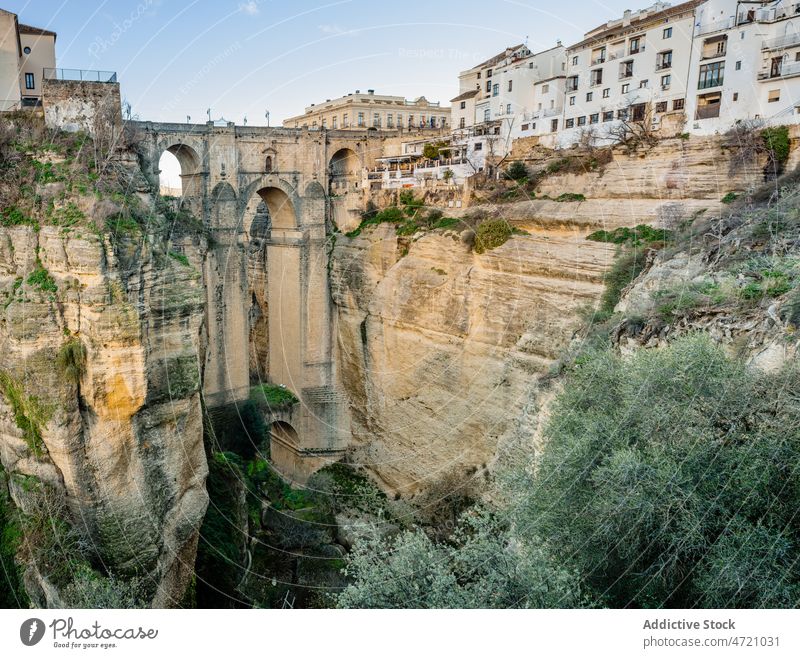 Old stone bridge between rocky cliffs in town gorge architecture sightseeing heritage historic aqueduct house scenery travel tourism residential arched