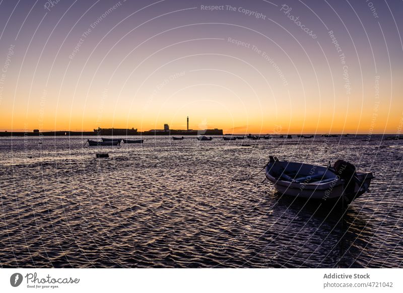 Sunset sky over wavy sea with floating boats sunset seascape nature landscape scenery resort silhouette paradise marine idyllic scenic picturesque cloudless