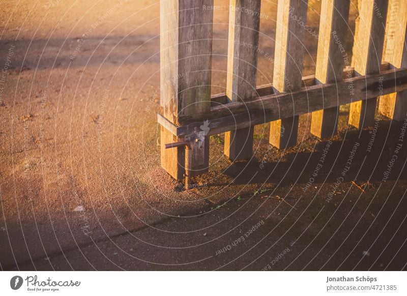 Wooden gate close up in evening sun Main gate Goal Entrance Fence Wooden fence open Open Light Shadow Close-up Evening sun evening light in the evening