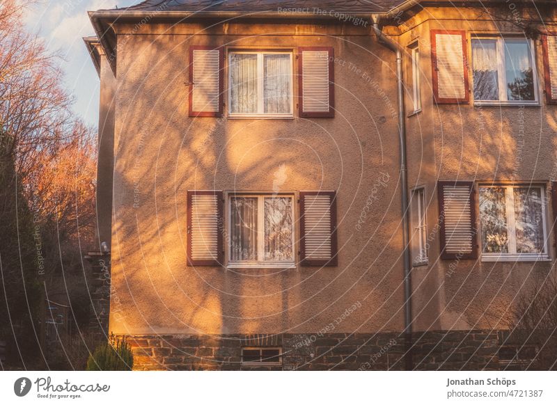 Facade old building house with shutters with shadow in evening light Old building House (Residential Structure) Shutter Shadow Apartment house Home Outskirts