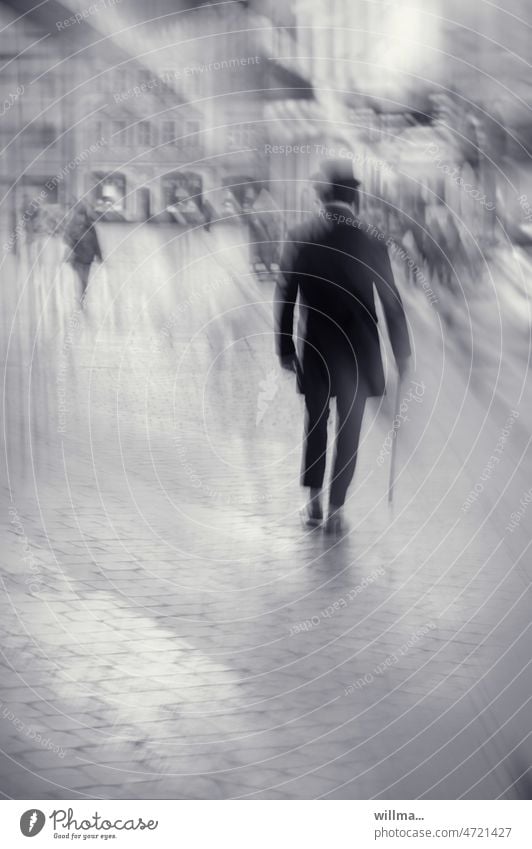 The time traveler. Elegant man with top hat, frock coat and walking stick in the city, unrecognizable, from behind. Man Frock coat Cylinder Walking stick stroll