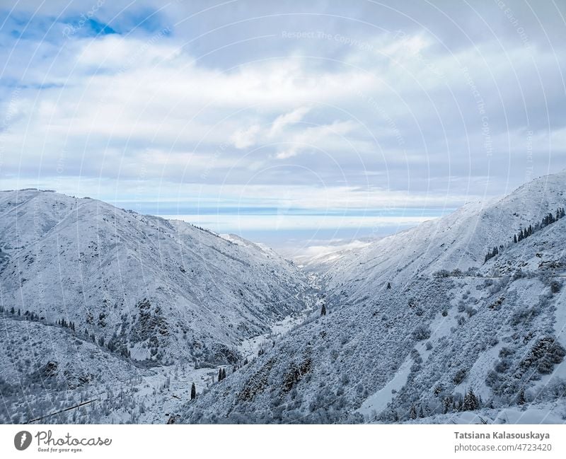 Winter mountain landscape against the blue sky with clouds winter cold frozen chilly mountains peak Hill vertex slope winter time frost freezing hoarfrost Snow