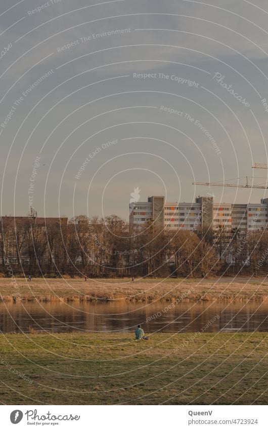 Person sitting alone on the banks of the Elbe in Dresden Elbufer Lonely Loneliness City trip Vacation & Travel Being alone depression person Sit River bank Town