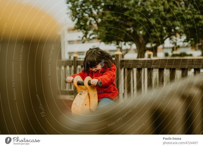 Cute girl playing in the playground Girl 3 - 8 years Child childhood Playing Playground playground equipment Authentic Kindergarten Leisure and hobbies Happy