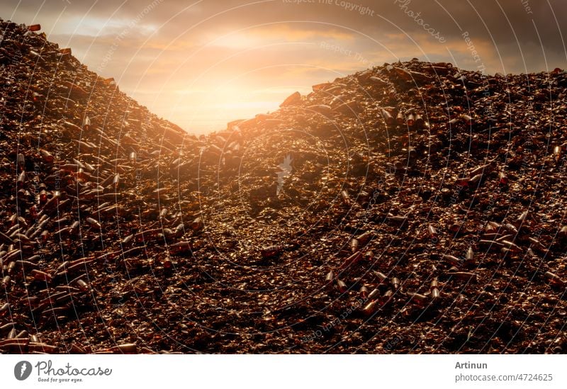 Pile of brown bottle for recycle in recycling factory. Glass waste for recycle. Dump of brown beer and wine glass bottle. Smashed glass bottle garbage. Recycling business. Sustainable glass packaging.