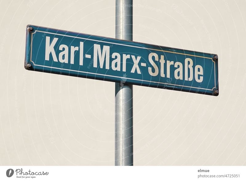 blue street name sign - Karl-Marx-Straße - on an iron bar / live Karl-Marx-Strasse Street sign iron rod Signs and labeling Charles Marx Philosophy address Past