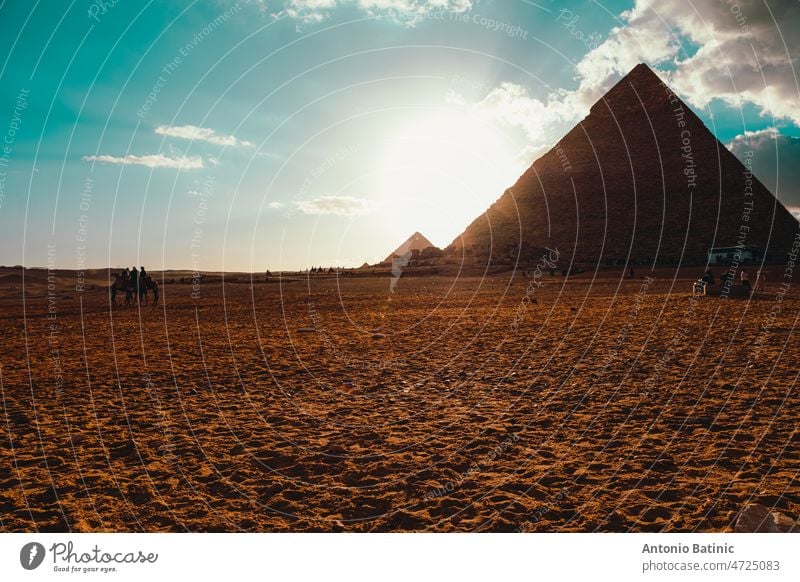 View of the giza pyramid in cairo egypt. One large one in the foreground and a small one in the distance. wonder of the world egypt pyramids pyramids of giza