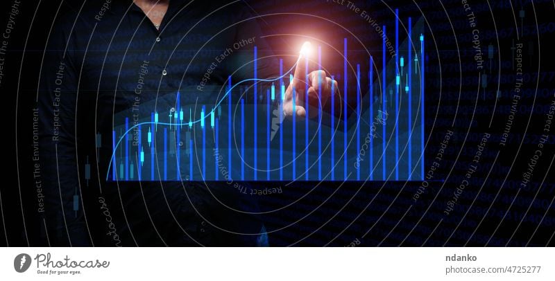 businessman in a suit stands in front of a holographic graph with growing figures, business growth, high income. Trading on the stock exchange analyzing arm