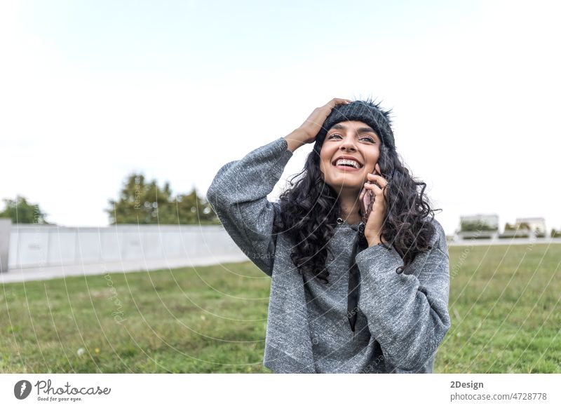 Closeup portrait of a cheerful young woman making a phone call outdoors in the city person lifestyle female happy mobile beautiful mobile phone communication