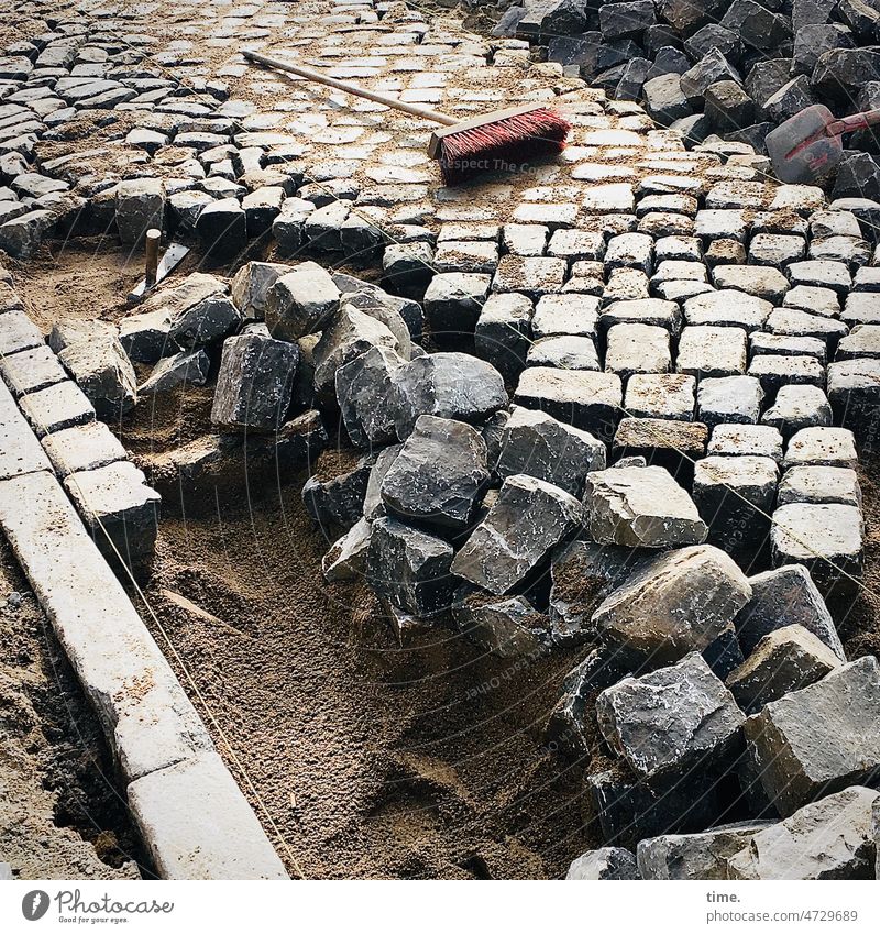 public workshop | waiting for the return of the publisher Broom stones Paving stone Road construction Sand off Workplace paving Pile of stones carpeting