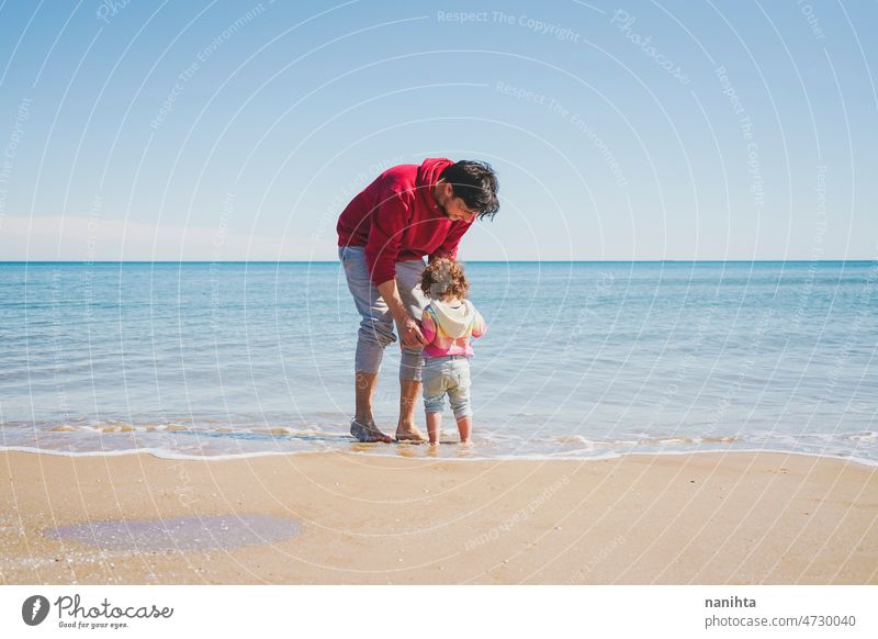 Young single dad take his little daughter to discover the sea family love baby girl beach holidays explore travel rainbow respectful childrearing harmony join