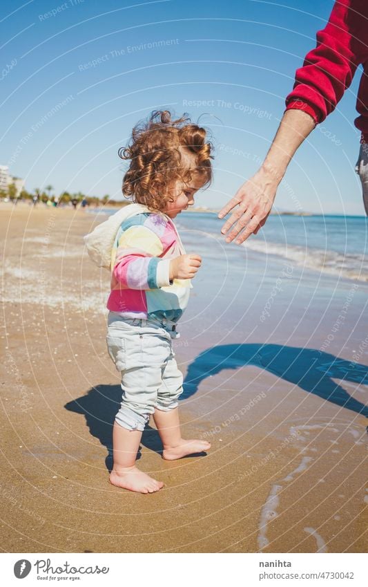 Young single dad take his little daughter to discover the sea family love baby girl beach holidays explore travel rainbow respectful childrearing harmony join