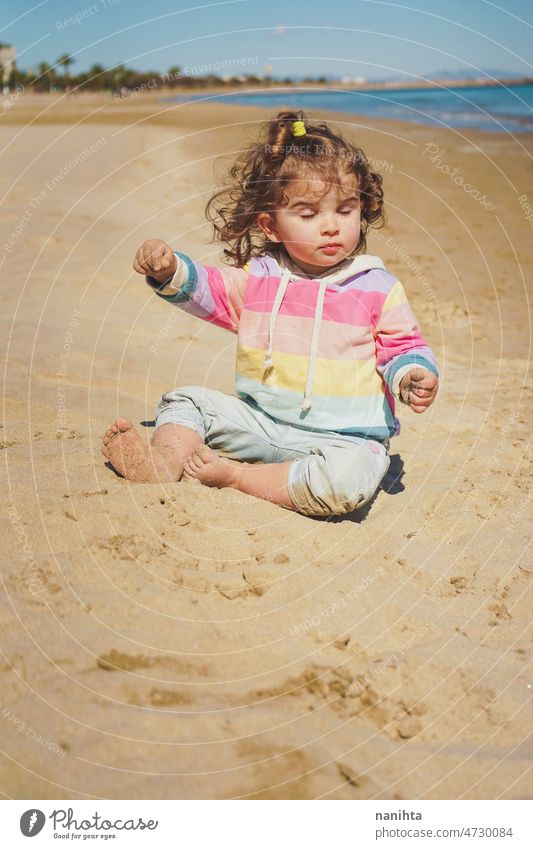 Little girl having meditation time at the beach mindfulness yoga balance equilibrium baby spiritual conscius toddler child holidays season summer summer time