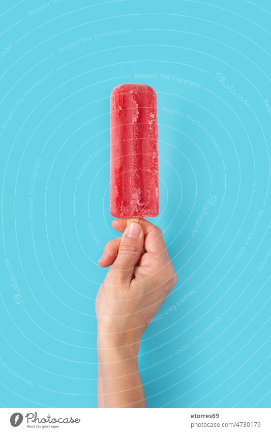 Hand holding a strawberry popsicle background cold colorful cool cream dessert flavor food fresh frosty frozen fruit hand homemade ice icecream iced juice lolly