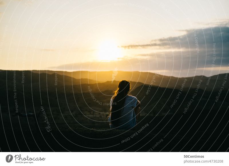 Lonely sunset Sunset Back-light Sunlight Landscape Exterior shot person Colour photo Sunbeam Nature Beautiful weather Sky mountains Desert long hairs Woman