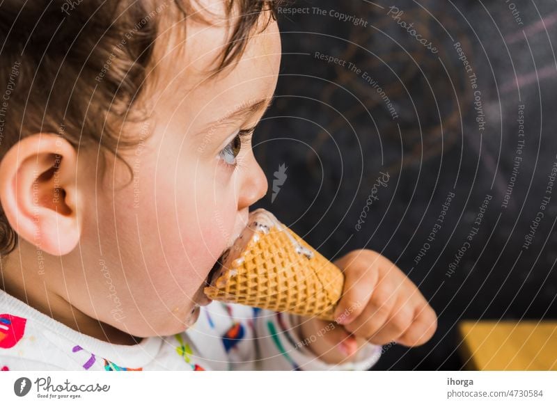 A baby eating ice cream background beautiful boy caucasian child closeup cute dessert face family food fun funny happy healthy hug ice-cream joy kid kids