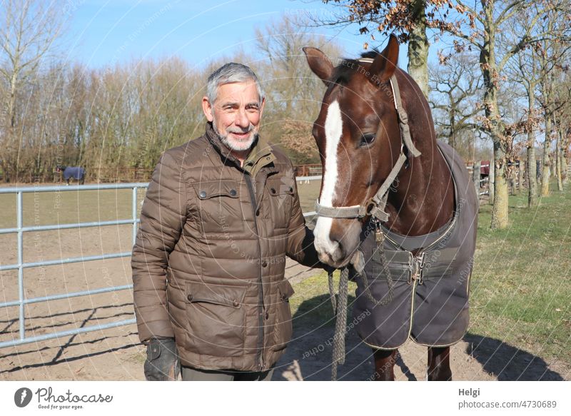 favorite hobby - senior and his horse stand outside on the riding arena Human being Man Senior citizen Horse Joy fun in common Spring Equestrian sports portrait