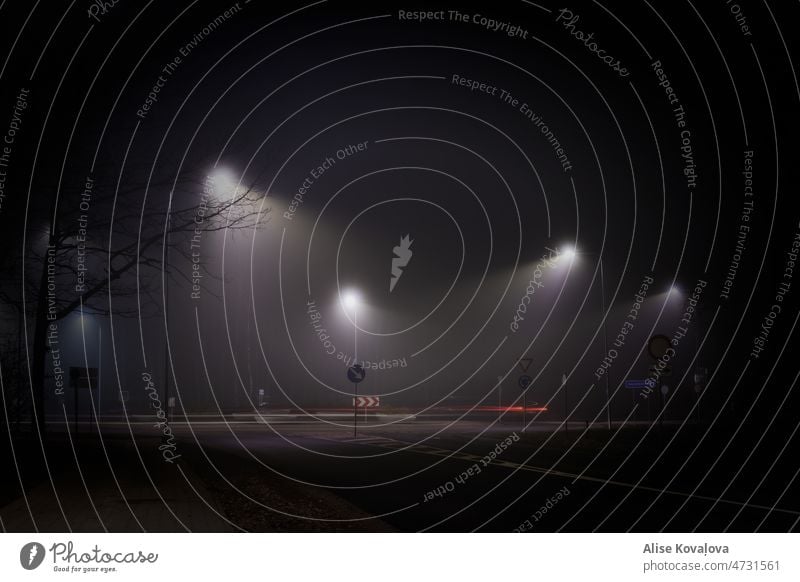 roundabout at night street darkness Night street signs street at night car rear lights Dark Fog foggy weather street lights lamp night time Peaceful