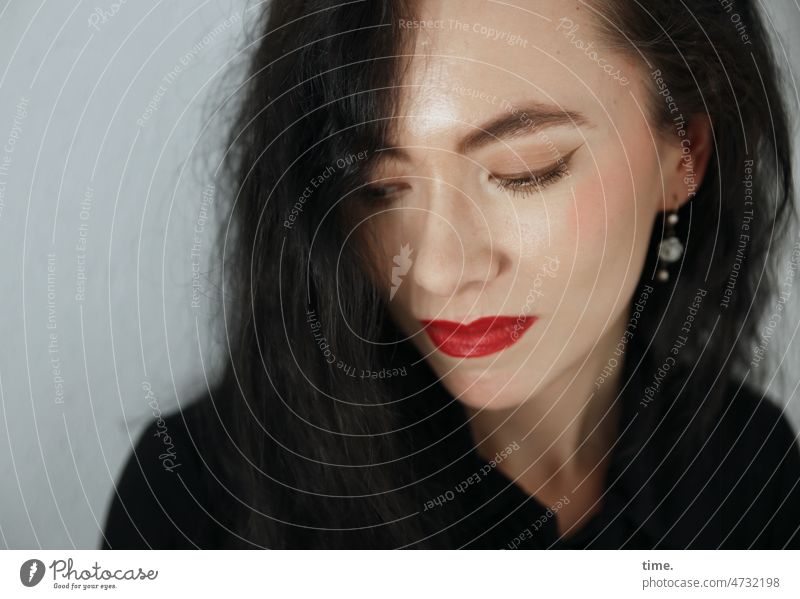 Woman with lowered eyes portrait Dark-haired Long-haired Lipstick Jewellery Downward