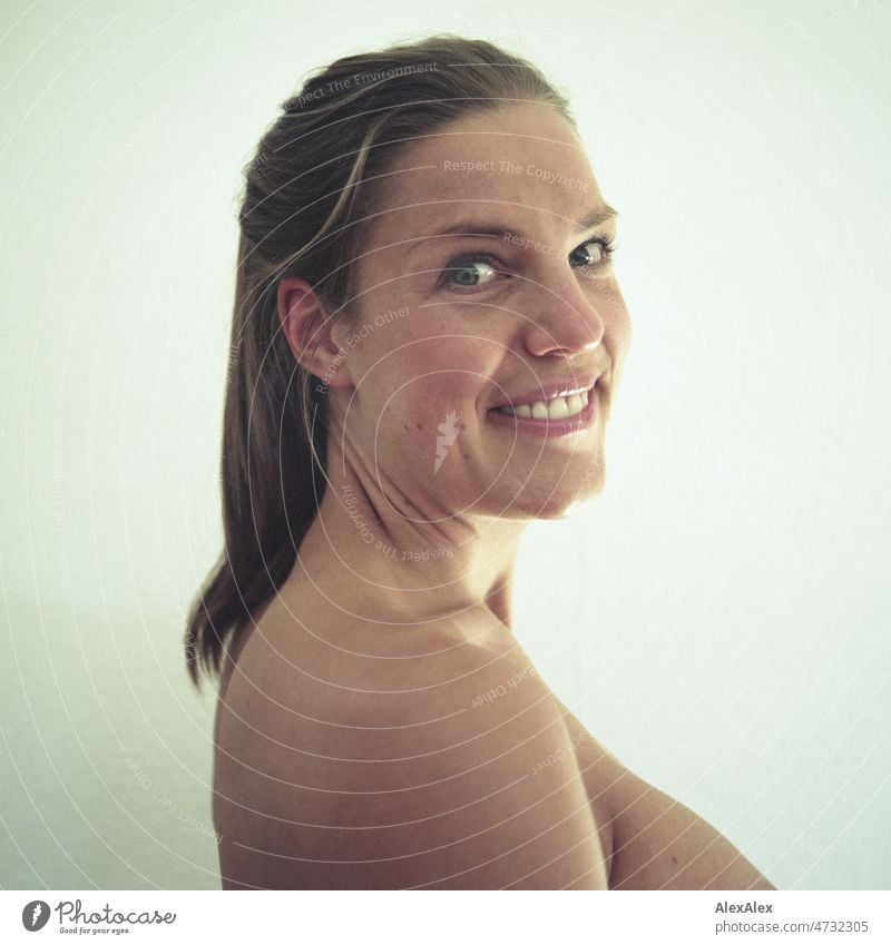 analog side portrait of young tall blonde woman with ponytail hairstyle and dimples smiling at camera Woman pretty Large Slim Esthetic Athletic fit naturally