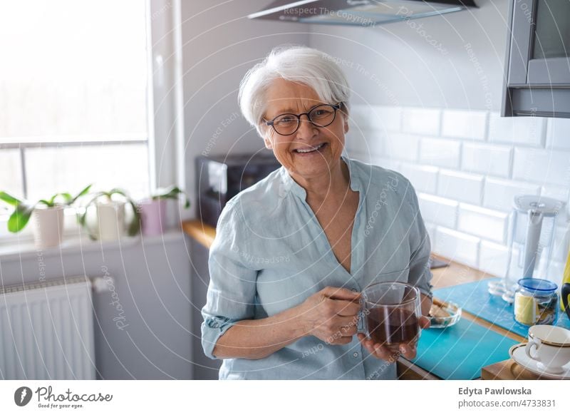 Shot of a senior woman in her kitchen alone at home domestic life elderly female grandma grandmother grey hair house indoors lifestyle mature old older