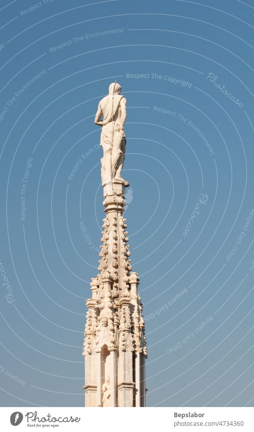 Statue on the spire Italy above architecture cathedral church commemorative faith high historic holiness holy isolated milano monument religion sculpt sculpture