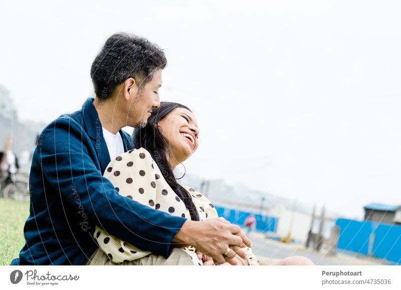 Close up portrait of attractive young couple in love outdoors. paruvian Latin American woman beautiful happy smiling together flower beach girl summer face