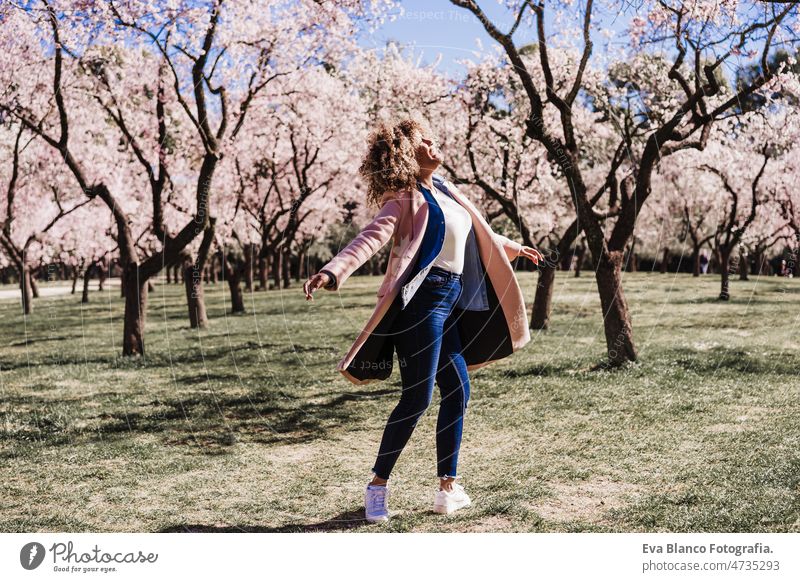 Curvy happy hispanic woman with eyes closed in park dancing on sunny day. Spring. Body positivity curvy body positivity afro spring size flowers portrait