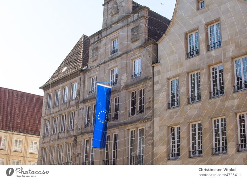 The European flag flies on a historic building at Prinzipalmarkt in Münster, Westphalia, Germany Flag Sign Peace Building Münster in Westphalia Window