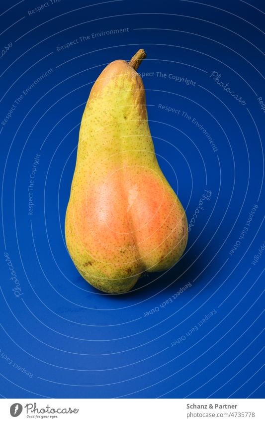 Pear with red bottom on blue background fruit salubriously Nutrition Sunburn Red Green Delicious Food Fresh Fruit Healthy Organic produce cute Juicy