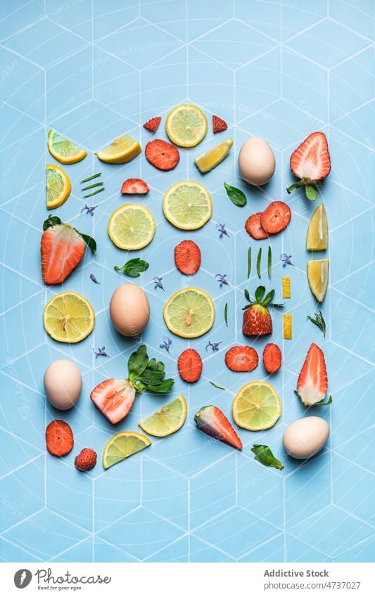 Composition of fruits berries and eggs on geometric background lemon lime flat lay strawberry creative slice fresh composition piece geometry citrus ingredient