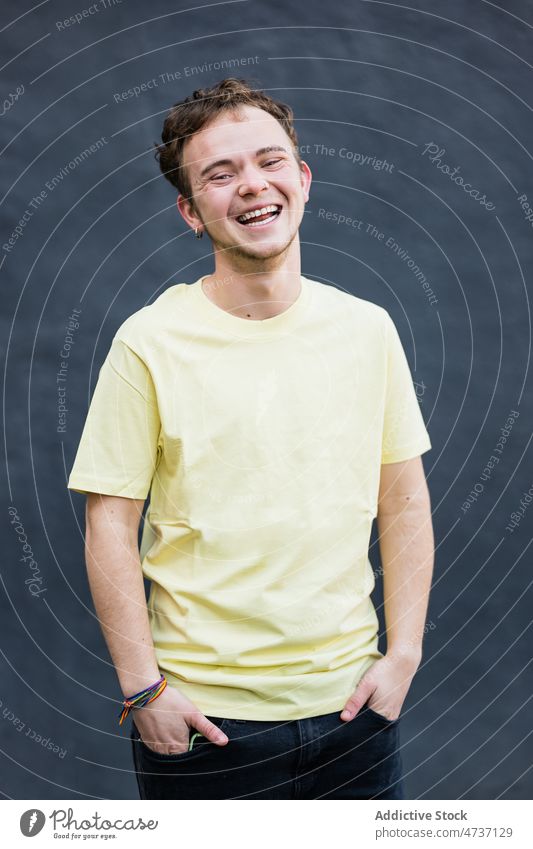 Young man looking at camera in studio appearance model short hair individuality style personality brown hair portrait male green eyes calm indifferent earring