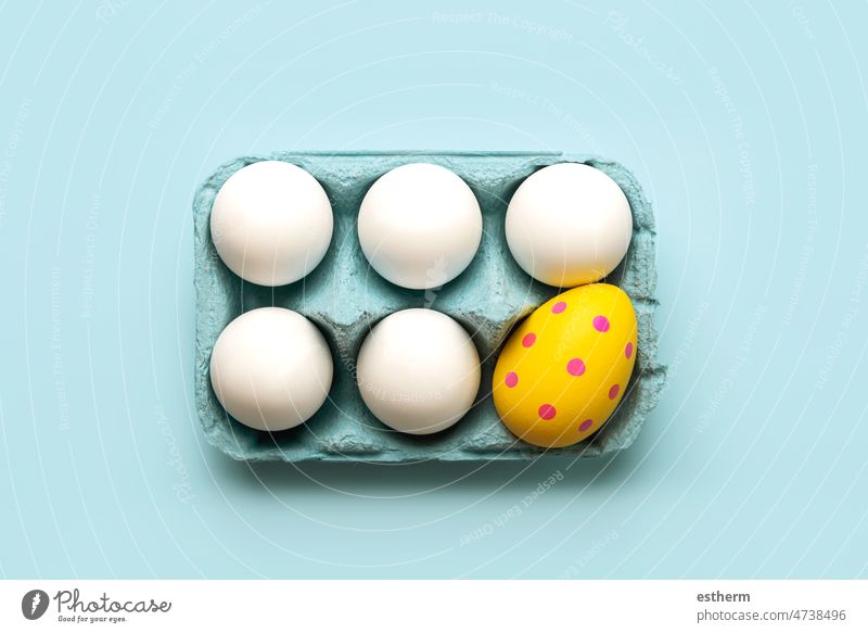 Happy Easter. Top view of chicken eggs and easter painted egg in an open blue cardboard box painted eggs happy easter abstract sweet still life colored easter