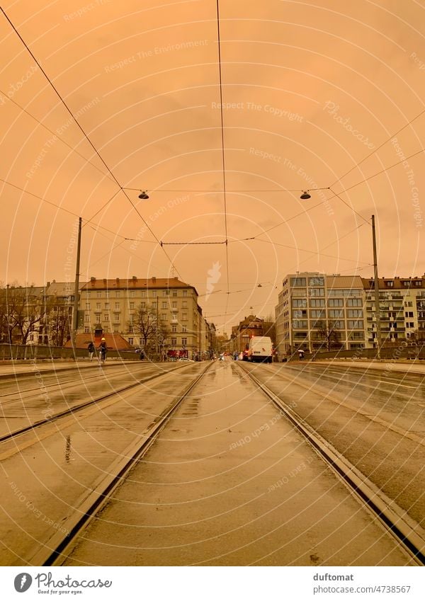 Sahara dust during rain on streetcar tracks in Munich Orange City life Dust Air Weather Weather phenomenon Sand Sky Street Wet Rain Railroad tracks